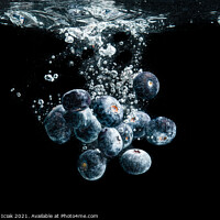 Buy canvas prints of Blueberries splashing in water on black by Przemek Iciak