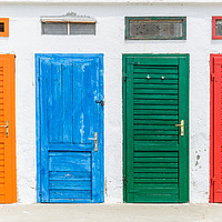 Buy canvas prints of Colourful doors painted in orange, blue, green and by Przemek Iciak