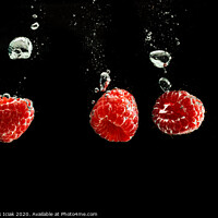 Buy canvas prints of Raspberries splashing into clear water isolated on black background. by Przemek Iciak
