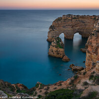 Buy canvas prints of Natural arch cliffs of Praia da Marinha beach at sunset beautiful landscape with atlantic ocean, in Lagoa Portugal by Luis Pina