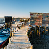 Buy canvas prints of Carrasqueira Palafitic Pier in Comporta, Portugal with fishing boats by Luis Pina