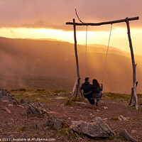 Buy canvas prints of Romantic couple swinging on a Swing baloico in Lousa mountain, Portugal at sunset by Luis Pina