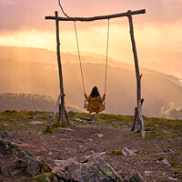 Buy canvas prints of Woman girl social distancing swinging on a Swing baloico in Lousa mountain, Portugal at sunset by Luis Pina