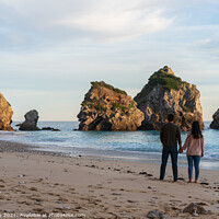 Buy canvas prints of Couple holding hands on a wild empty beach in Ribeiro do Cavalo, Arrabida, Portugal by Luis Pina