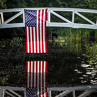 Buy canvas prints of American flag hanging from wooden bridge in Somesv by Miro V