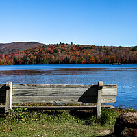 Buy canvas prints of Wooden bench with colored autumn mountains by Miro V