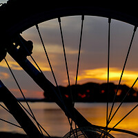 Buy canvas prints of Wheel silhouette from bike and sunrise light  by Miro V