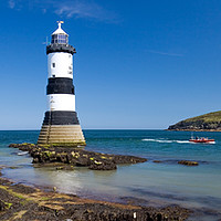 Buy canvas prints of Puffin Island and Trwyn Du lighthouse. by mark baker