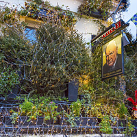 Buy canvas prints of The Churchill Arms Pub Restaurant Kensington London England by William Perry