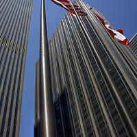 Buy canvas prints of Steel Buildings Skyscrapers and Flags New York City by William Perry