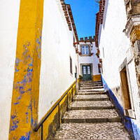 Buy canvas prints of Narrow White Street 11th Century Mediieval City Obidos Portugal by William Perry
