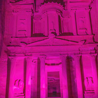 Buy canvas prints of Bright Pink Treasury Illuminated Night Petra Jordan  by William Perry