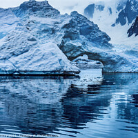 Buy canvas prints of Snowing Floating Blue Iceberg Arch Paradise Bay Antarctica by William Perry