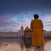 Buy canvas prints of Amritsar, India: Unidentified Sikh Guard with spear standing and looking around near Sri Harmandir Sahib or Golden Temple pond against dramatic sunrise and birds in the sky by Arpan Bhatia