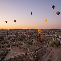 Buy canvas prints of Cappadocia, Turkey - September 14, 2021: Wide angle aerial panoramic shot of colorful hot air balloons together floating in the sky at early morning sunrise horizon in Goreme national park by Arpan Bhatia