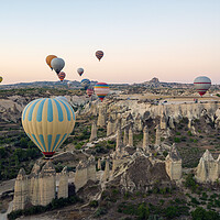 Buy canvas prints of Colorful hot air balloons in the sunrise autumn morning. Goreme National Park, Cappadocia, Turkey. Aerial view by Arpan Bhatia