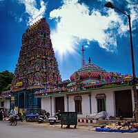 Buy canvas prints of Pondicherry, India -: Wide angle shot of An Indian colorful temple named Vedapureeswarar exterior displaying beautiful hindu architecture with gods sculpture carved on it's built. by Arpan Bhatia