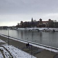 Buy canvas prints of Krakow, Poland - January 29, 2015: Wide angle view of famous wawel castle covered with snow next to vistual river against cloudy sky by Arpan Bhatia