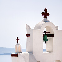 Buy canvas prints of A tower top of a church with cross sign and bells architecture located in oia village in one of Cycladic island in Santorini, Greece against sea. by Arpan Bhatia