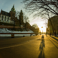 Buy canvas prints of Krakow, Poland - Road to the main entrance to royal Wawel Castle in Cracow and bicycle parked against sunset by Arpan Bhatia