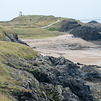 Buy canvas prints of Rocky beach and lighthouse of Ynys Llanddwyn by Christopher Keeley