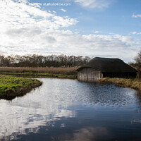 Buy canvas prints of Blue skies over Hickling Broad boat house by Christopher Keeley