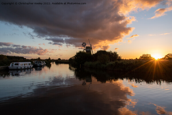 Sunset at Norfolk Broads windmill Picture Board by Christopher Keeley
