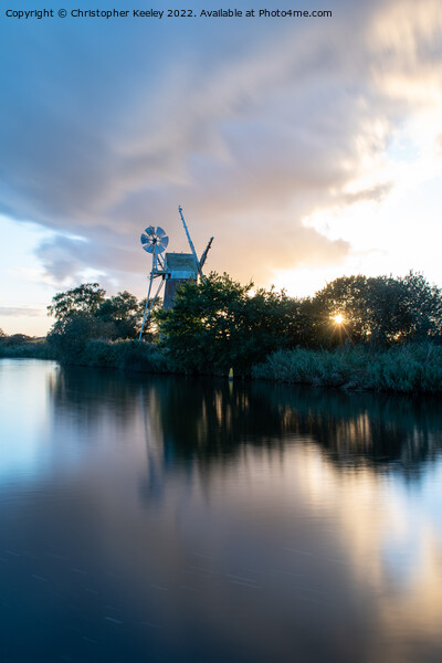 Sunset at Turf Fen windpump Picture Board by Christopher Keeley