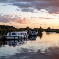 Buy canvas prints of Sunset over Norfolk Broads boats by Christopher Keeley
