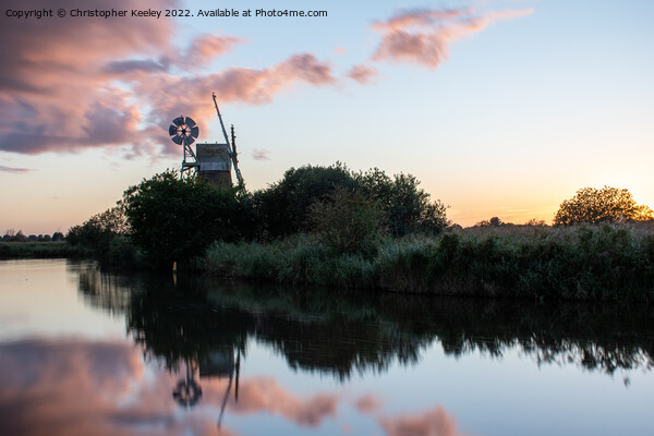 Sunset reflections at How Hill windmill Picture Board by Christopher Keeley