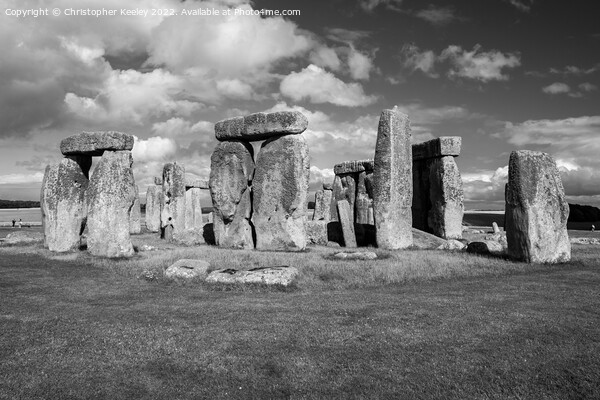 Cloudy skies over Stonehenge in black and white Picture Board by Christopher Keeley