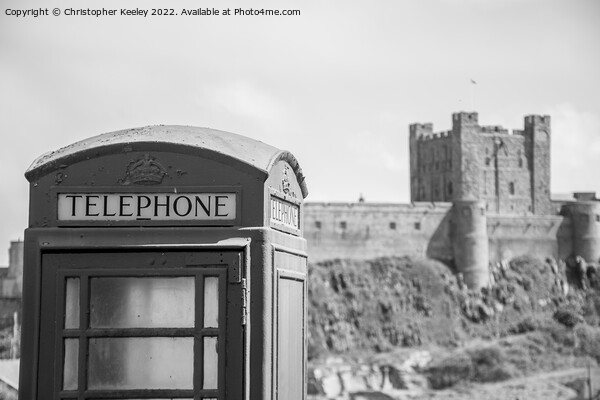 Black and white Bamburgh Castle telephone box Picture Board by Christopher Keeley