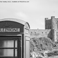 Buy canvas prints of Black and white Bamburgh Castle telephone box by Christopher Keeley