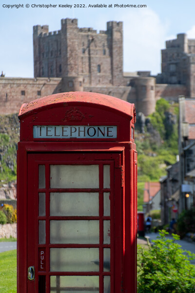 Telephone box at Bamburgh Castle Picture Board by Christopher Keeley