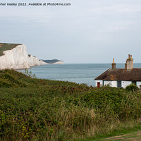 Buy canvas prints of Seven Sisters Cliffs and coastguard cottages by Christopher Keeley