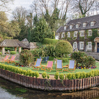 Buy canvas prints of Cotswolds hotel and deck chairs in Bibury by Christopher Keeley