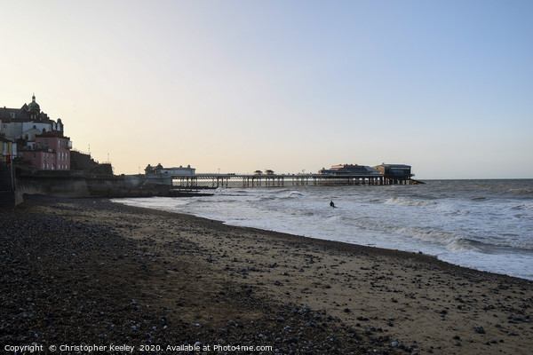 Cromer pier and beach at golden hour Picture Board by Christopher Keeley