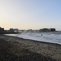 Buy canvas prints of Cromer pier and beach at golden hour by Christopher Keeley