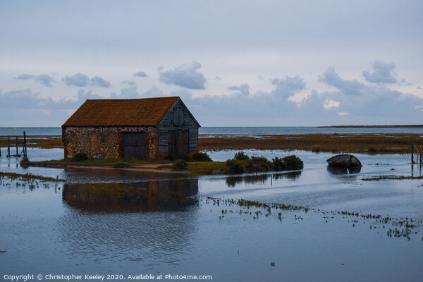 North Norfolk coal barn surrounded by sea Picture Board by Christopher Keeley