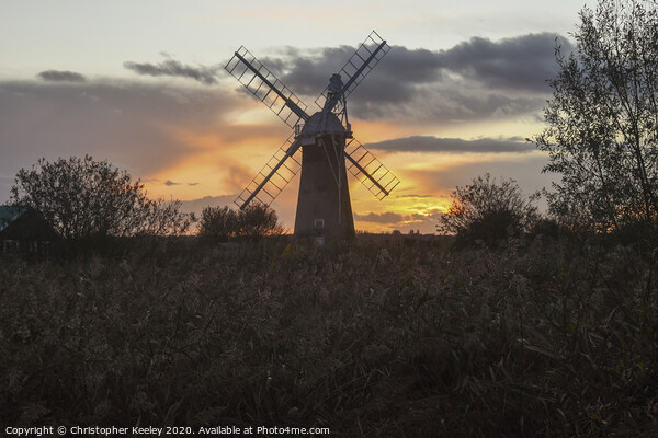 Norfolk windmill sunset Picture Board by Christopher Keeley