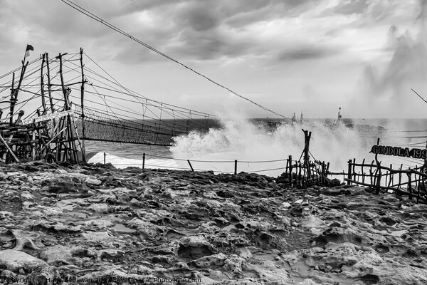Big wave hits swinging rope foot bridge to island Picture Board by Hanif Setiawan