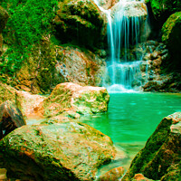 Buy canvas prints of A waterfall flowing over rocks into a lake. by Hanif Setiawan