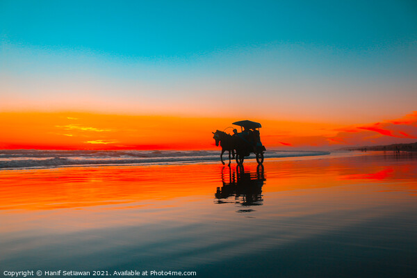 Horse-drawn carriage at sunset on beach Picture Board by Hanif Setiawan