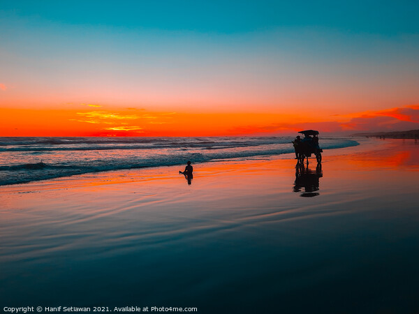 Horse-drawn carriage at sunset on beach Picture Board by Hanif Setiawan