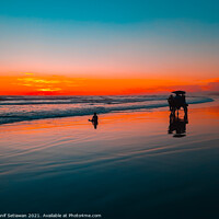 Buy canvas prints of Horse-drawn carriage at sunset on beach by Hanif Setiawan