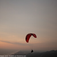 Buy canvas prints of Tandem paragliding over sea and beach at sunset by Hanif Setiawan
