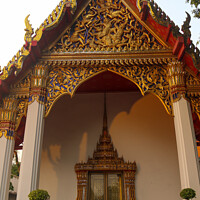 Buy canvas prints of Phra Viharn Kod entrance door and roof at Wat Pho  by Hanif Setiawan
