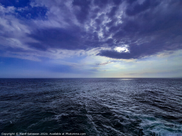 Wavy sea and dramatic cloud sky at sunset Picture Board by Hanif Setiawan