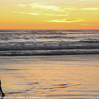 Buy canvas prints of A young boy on wet sand beach at sunset. by Hanif Setiawan