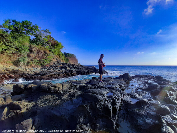 Day dreamer on coast rock plateau Picture Board by Hanif Setiawan